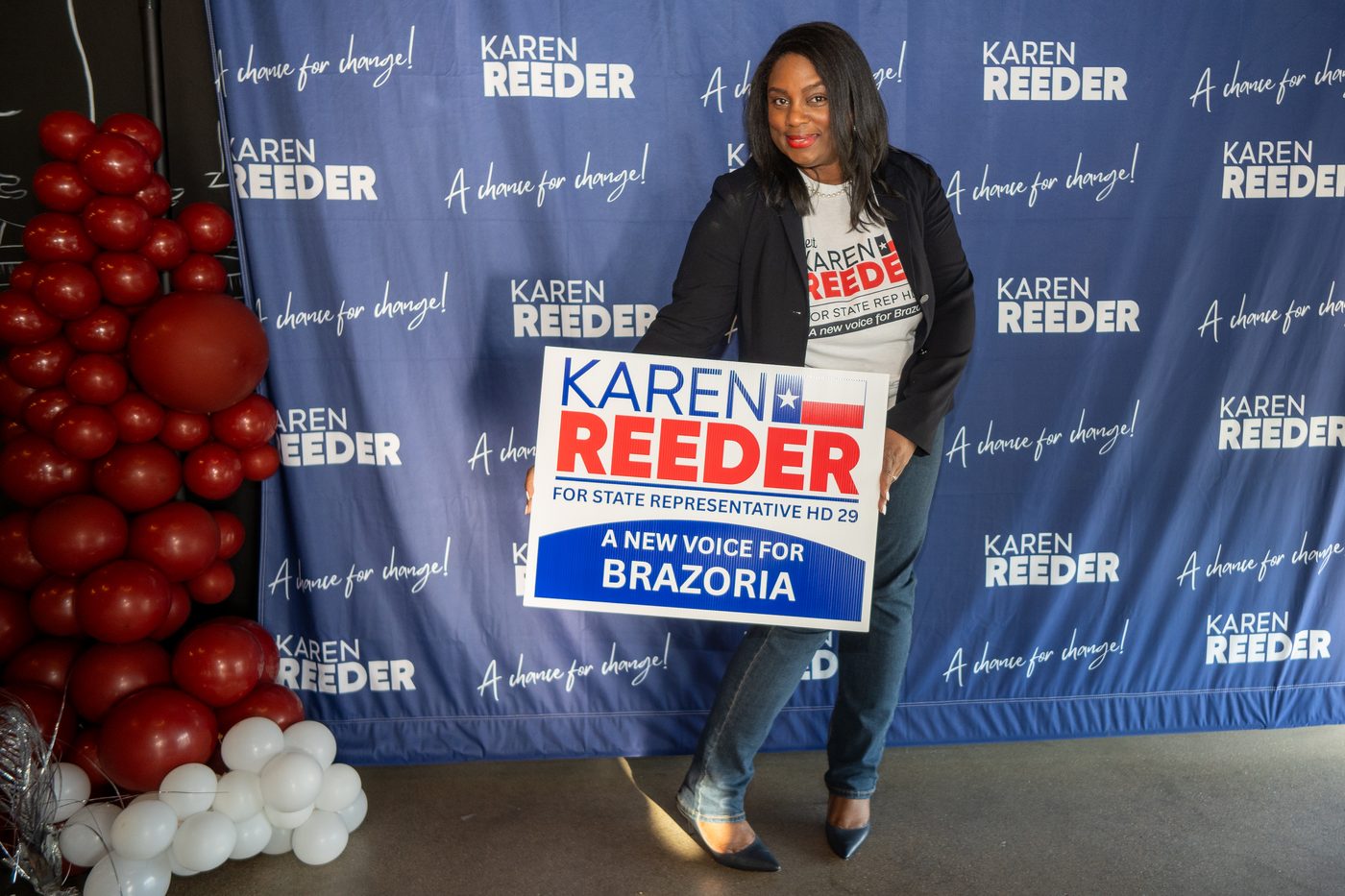Karen Reeder holding a campaign yard sign